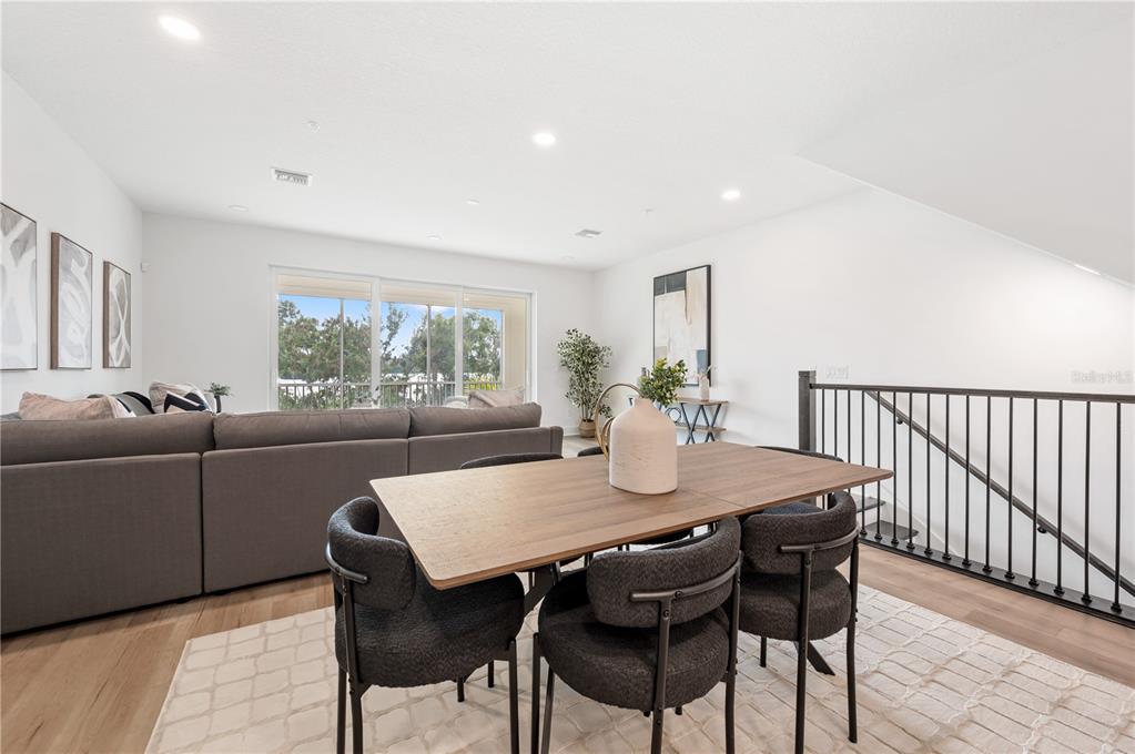 9992 Key Haven Road Seminole, FL 33777 - Photo 11 of 49 a view of a dining room and livingroom with furniture a large window and wooden floor