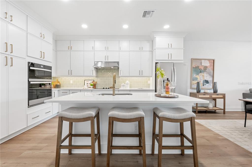 9992 Key Haven Road Seminole, FL 33777 - Photo 15 of 49 a kitchen with refrigerator a table and chairs