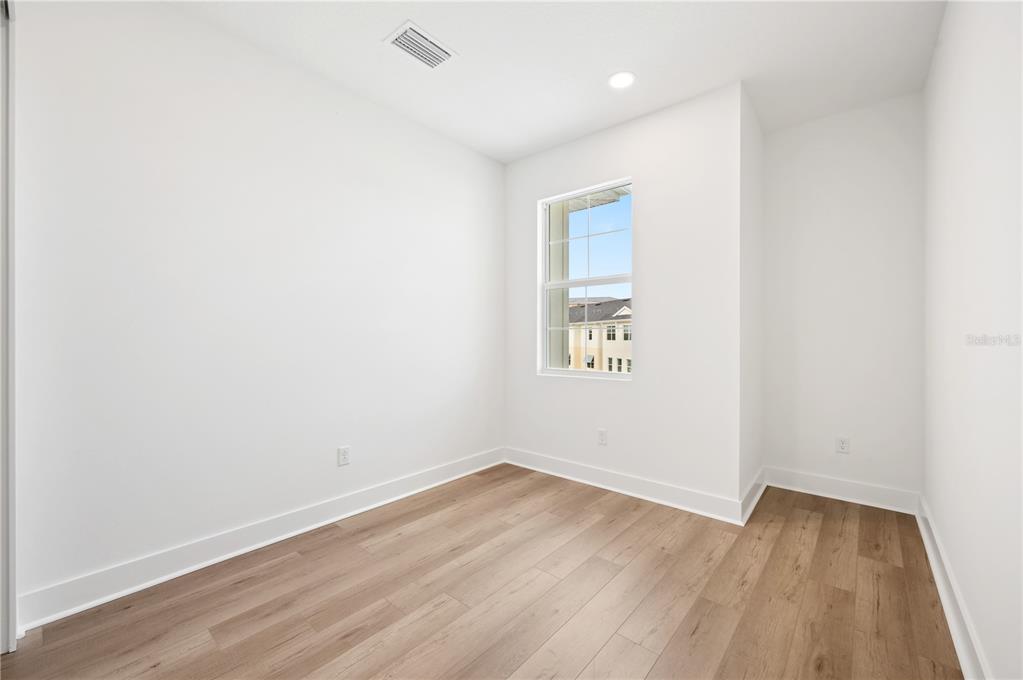 9992 Key Haven Road Seminole, FL 33777 - Photo 27 of 49 an empty room with wooden floor and windows