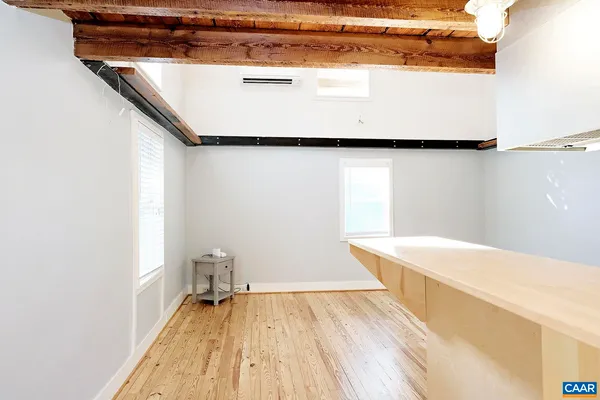 a view of a room with wooden floor