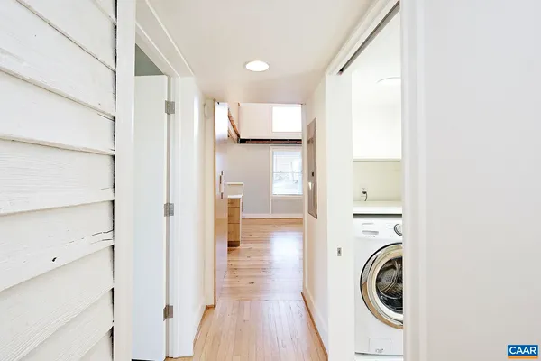a view of a hallway with washer and dryer