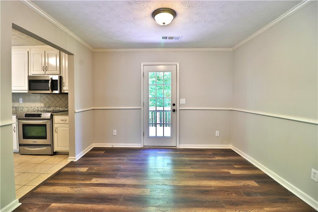 353 Fall View Court Winder, GA 30680 - Photo 30 of 61 a view of a livingroom with wooden floor and a window