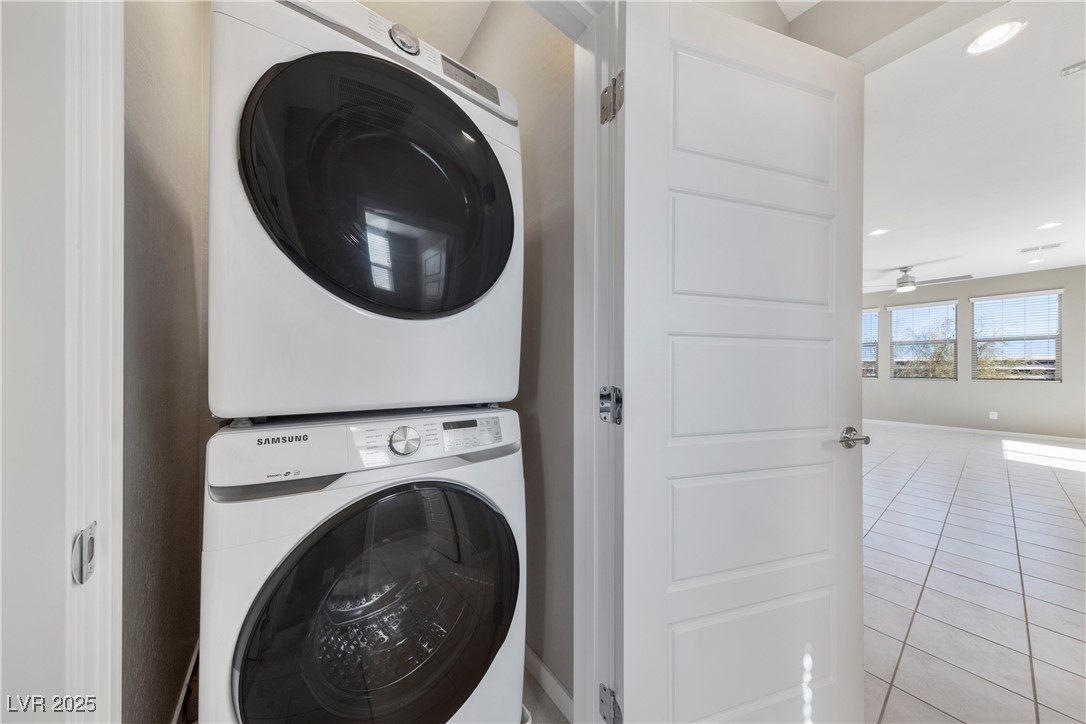 11238 Essence Point Avenue, Unit 201 Las Vegas, NV 89135 - Photo 16 of 52 Laundry room with tile patterned floors, stacked washer and clothes dryer, a ceiling fan, and recessed lighting