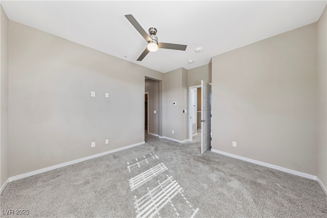 11238 Essence Point Avenue, Unit 201 Las Vegas, NV 89135 - Photo 24 of 52 Unfurnished room featuring carpet floors and a ceiling fan