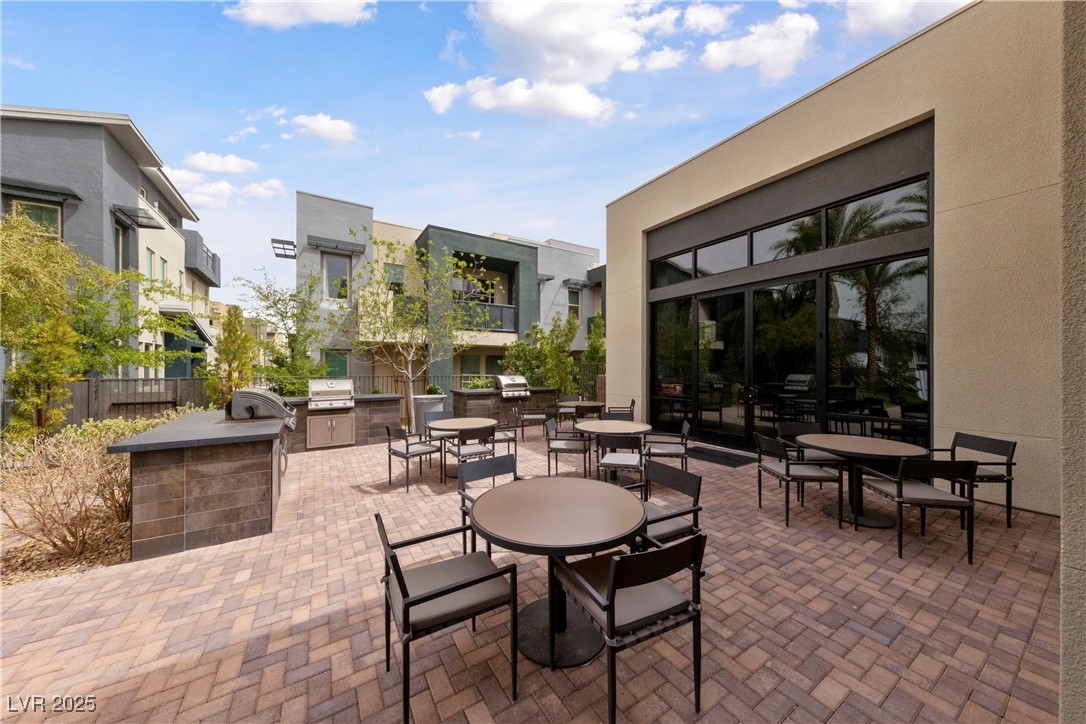 11238 Essence Point Avenue, Unit 201 Las Vegas, NV 89135 - Photo 36 of 52 View of patio featuring an outdoor kitchen and outdoor dining area