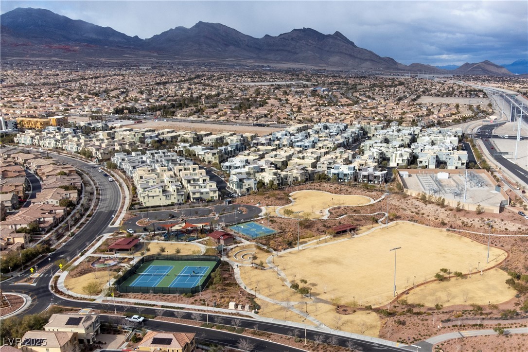 11238 Essence Point Avenue, Unit 201 Las Vegas, NV 89135 - Photo 49 of 52 Aerial view of property and surrounding area with a mountain backdrop and nearby suburban area