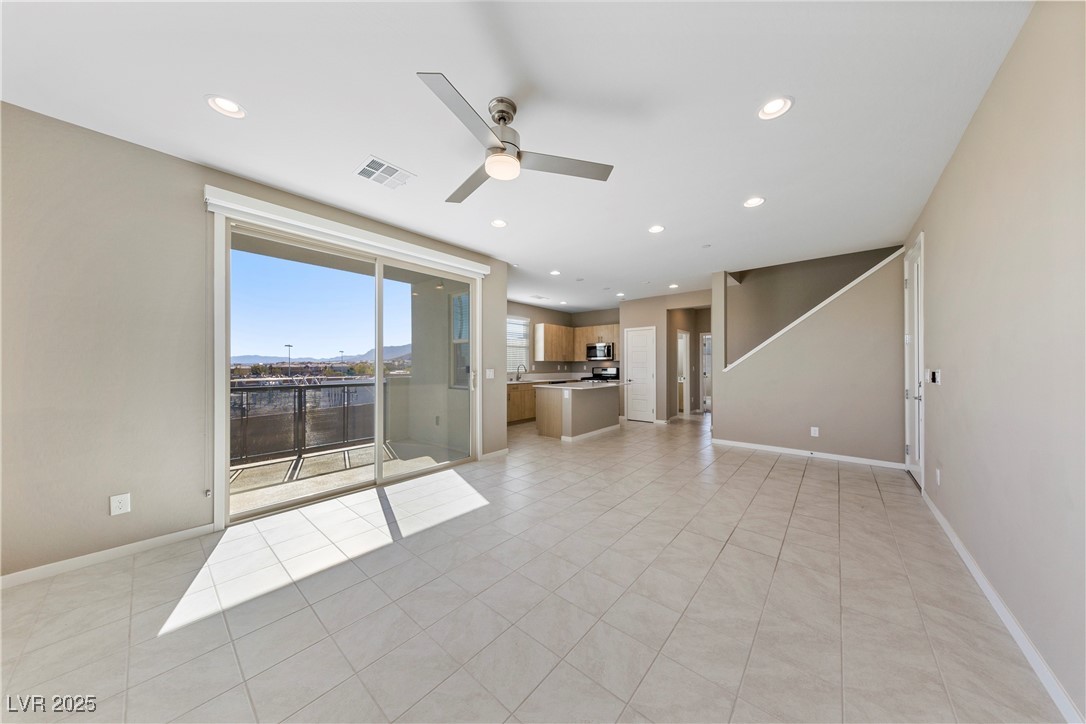 11238 Essence Point Avenue, Unit 201 Las Vegas, NV 89135 - Photo 6 of 52 Unfurnished living room with light tile patterned flooring, recessed lighting, a mountain view, and ceiling fan