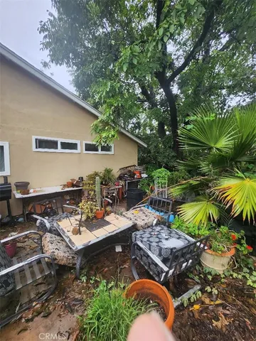 a backyard of a house with lots of green space and outdoor seating