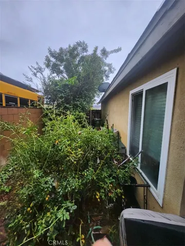 a view of house with trees in front