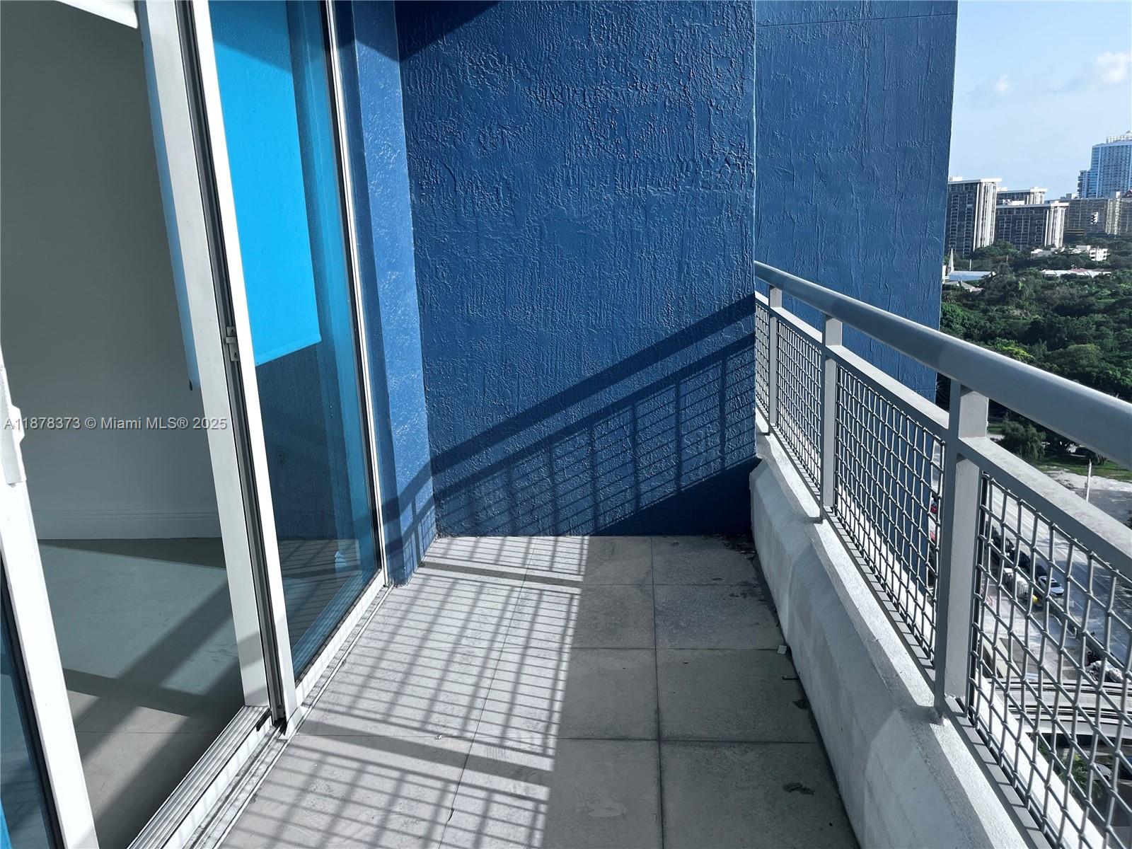 60 Southwest 13th Street, Unit 1417 Miami, FL 33130 - Photo 4 of 9 a view of balcony with wooden floor and stairs