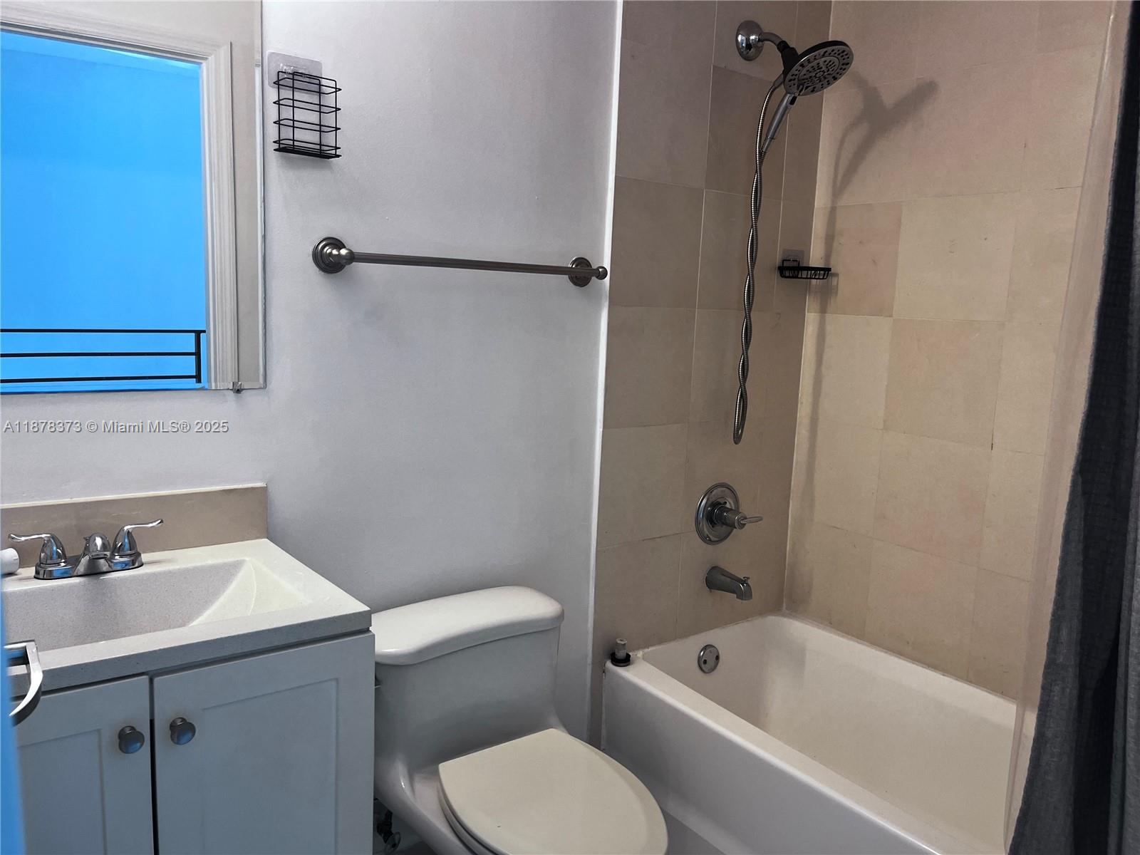 60 Southwest 13th Street, Unit 1417 Miami, FL 33130 - Photo 9 of 9 a bathroom with a sink a toilet and bathtub