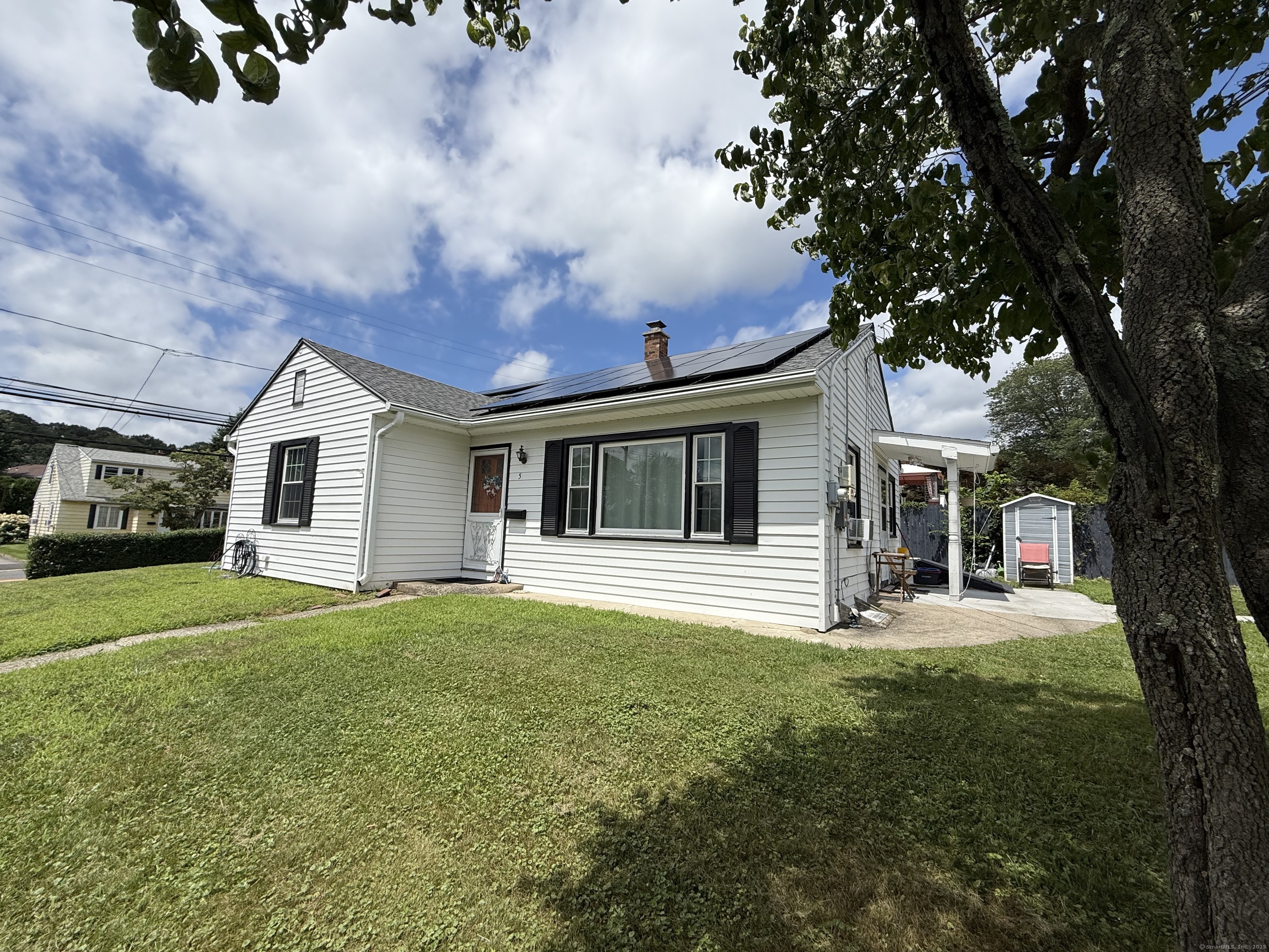 5 White Rose Avenue Waterbury, CT 06708 - Photo 1 of 1 a front view of a house with a garden and trees