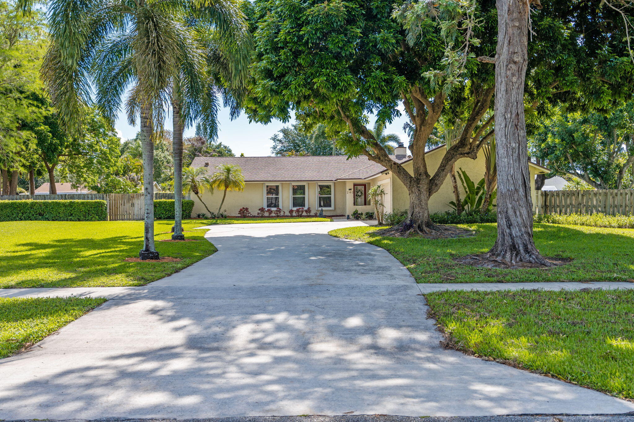 240 Sulky Way Wellington, FL 33414 - Photo 1 of 26 a view of a house with a big yard plants and palm trees