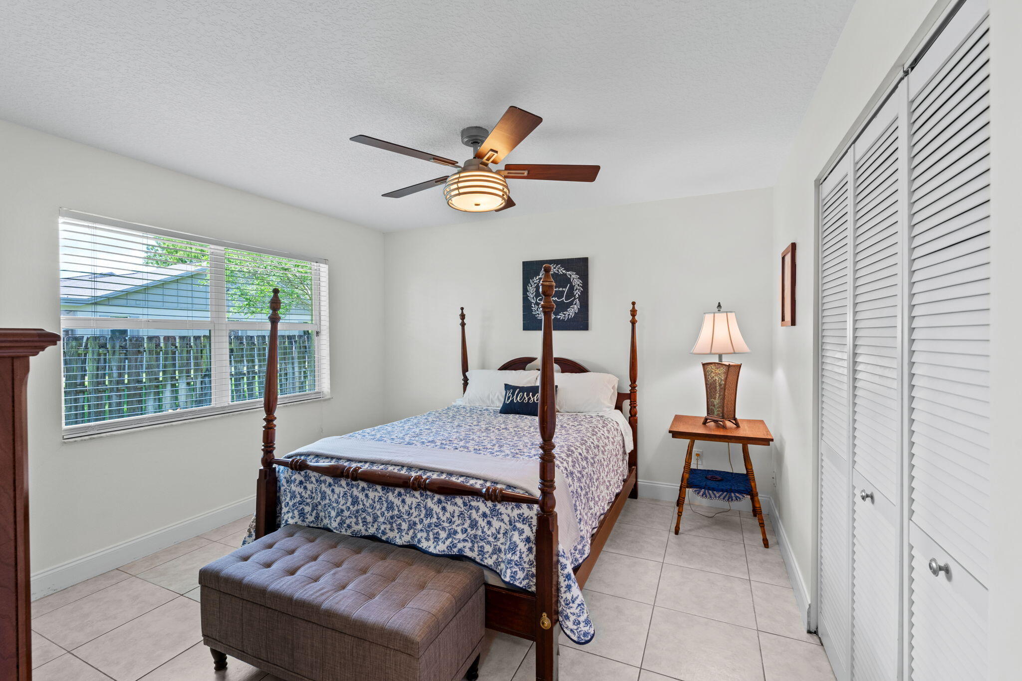 240 Sulky Way Wellington, FL 33414 - Photo 14 of 26 a bedroom with a bed and a chandelier