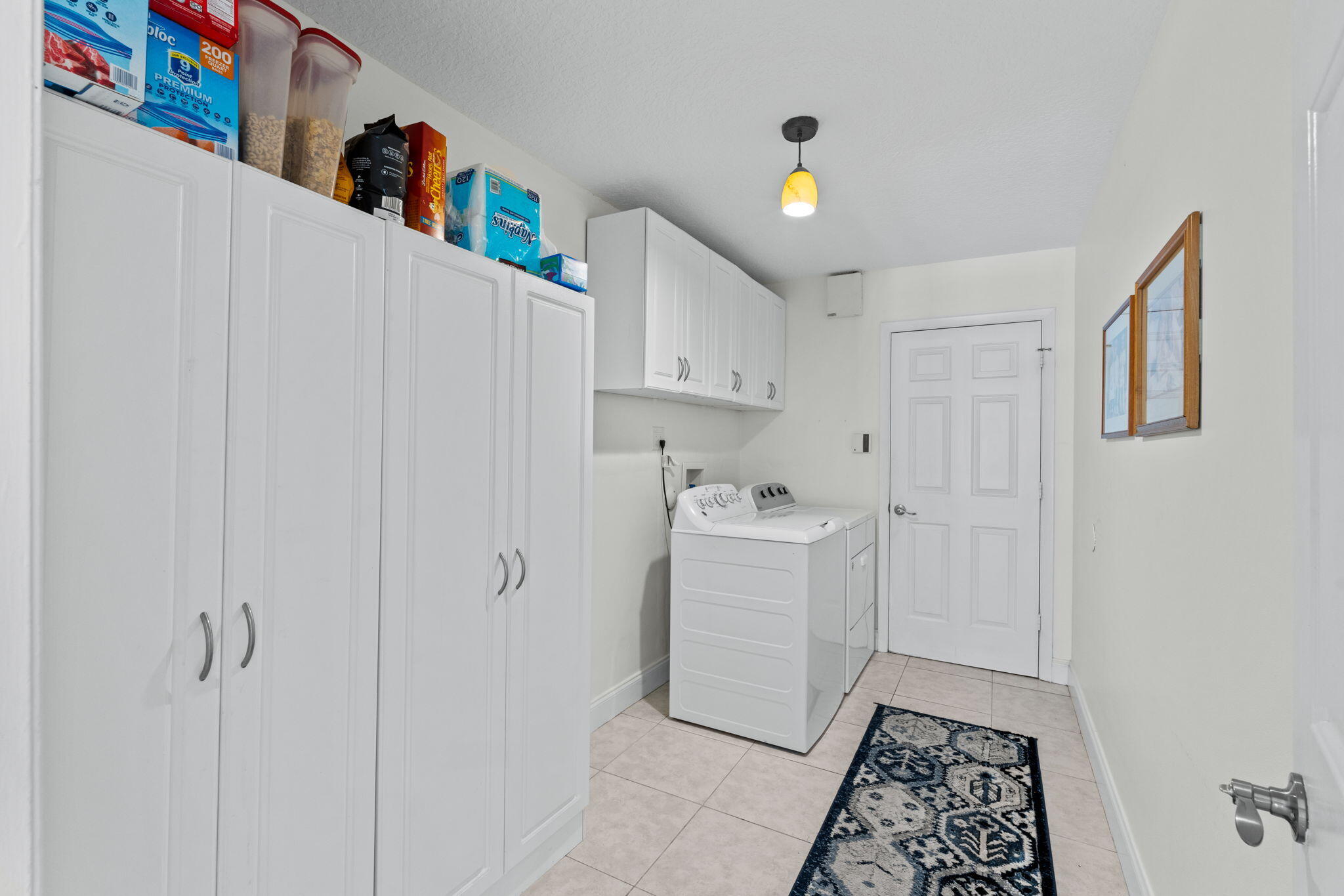 240 Sulky Way Wellington, FL 33414 - Photo 17 of 26 a room that has a lot of white cabinets and wooden floor