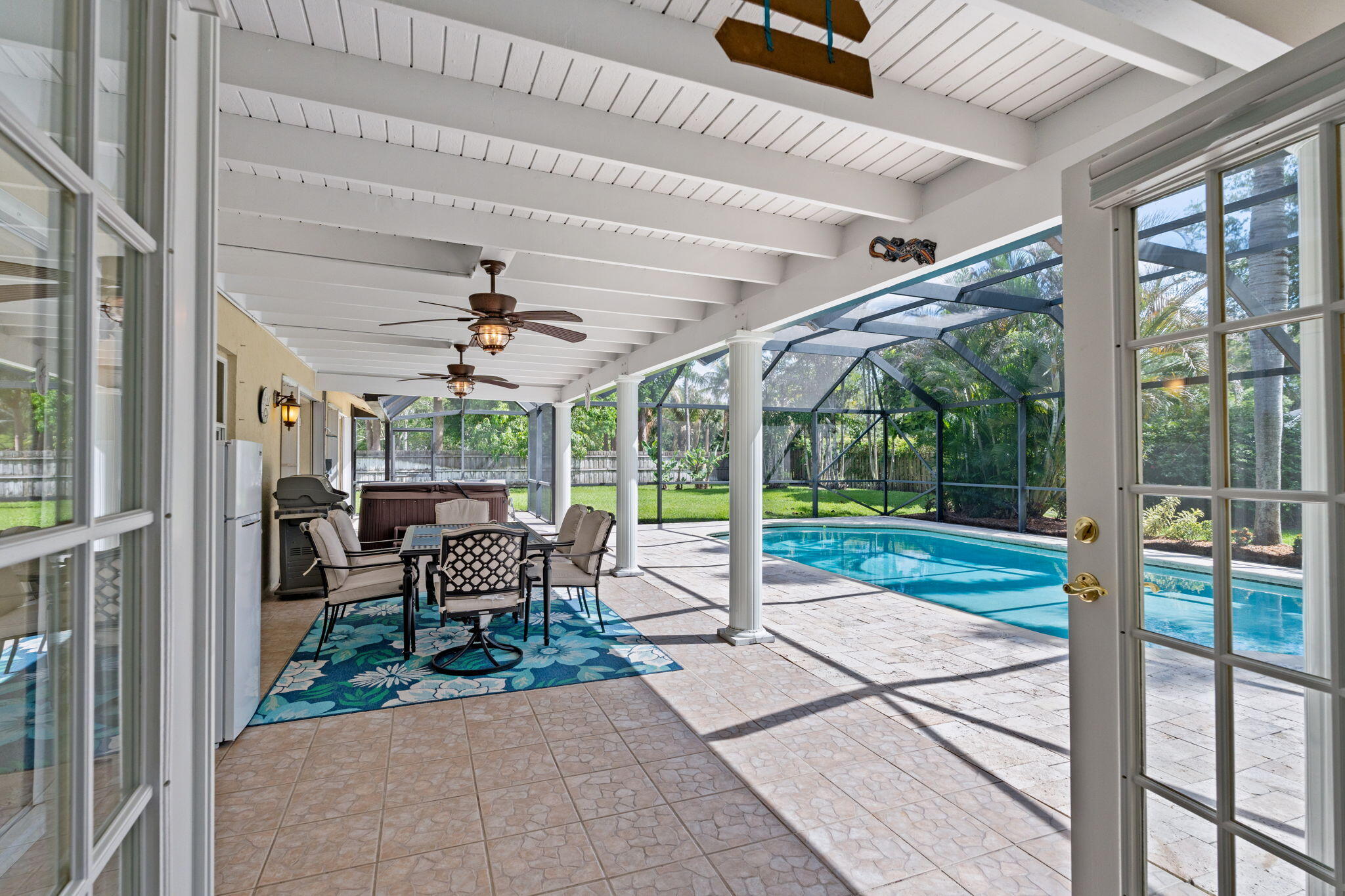 240 Sulky Way Wellington, FL 33414 - Photo 20 of 26 a view of a patio with table and chairs potted plants with floor to ceiling window