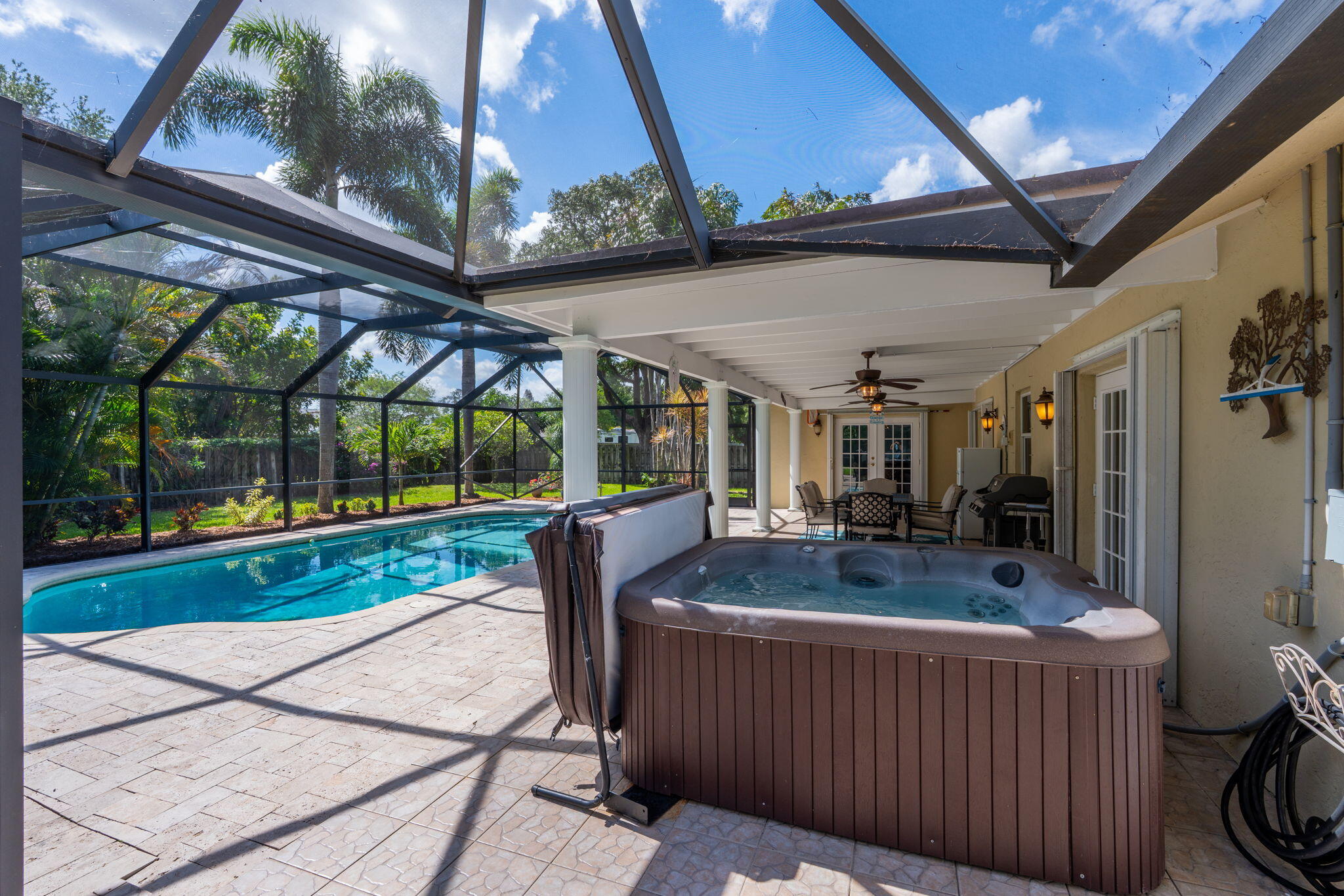 240 Sulky Way Wellington, FL 33414 - Photo 23 of 26 a view of a patio with a table and chairs