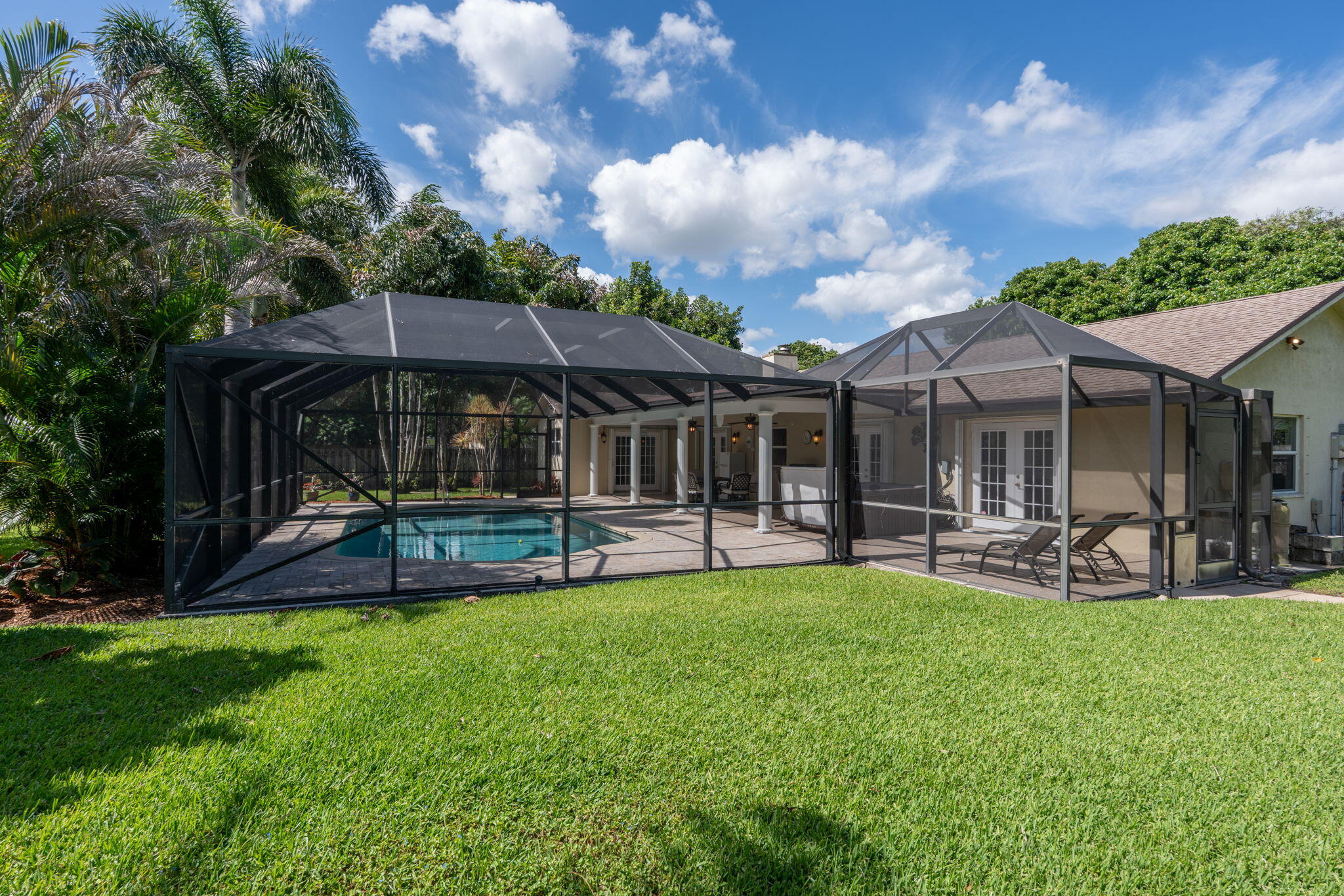 240 Sulky Way Wellington, FL 33414 - Photo 24 of 26 a view of a house with a backyard and sitting area
