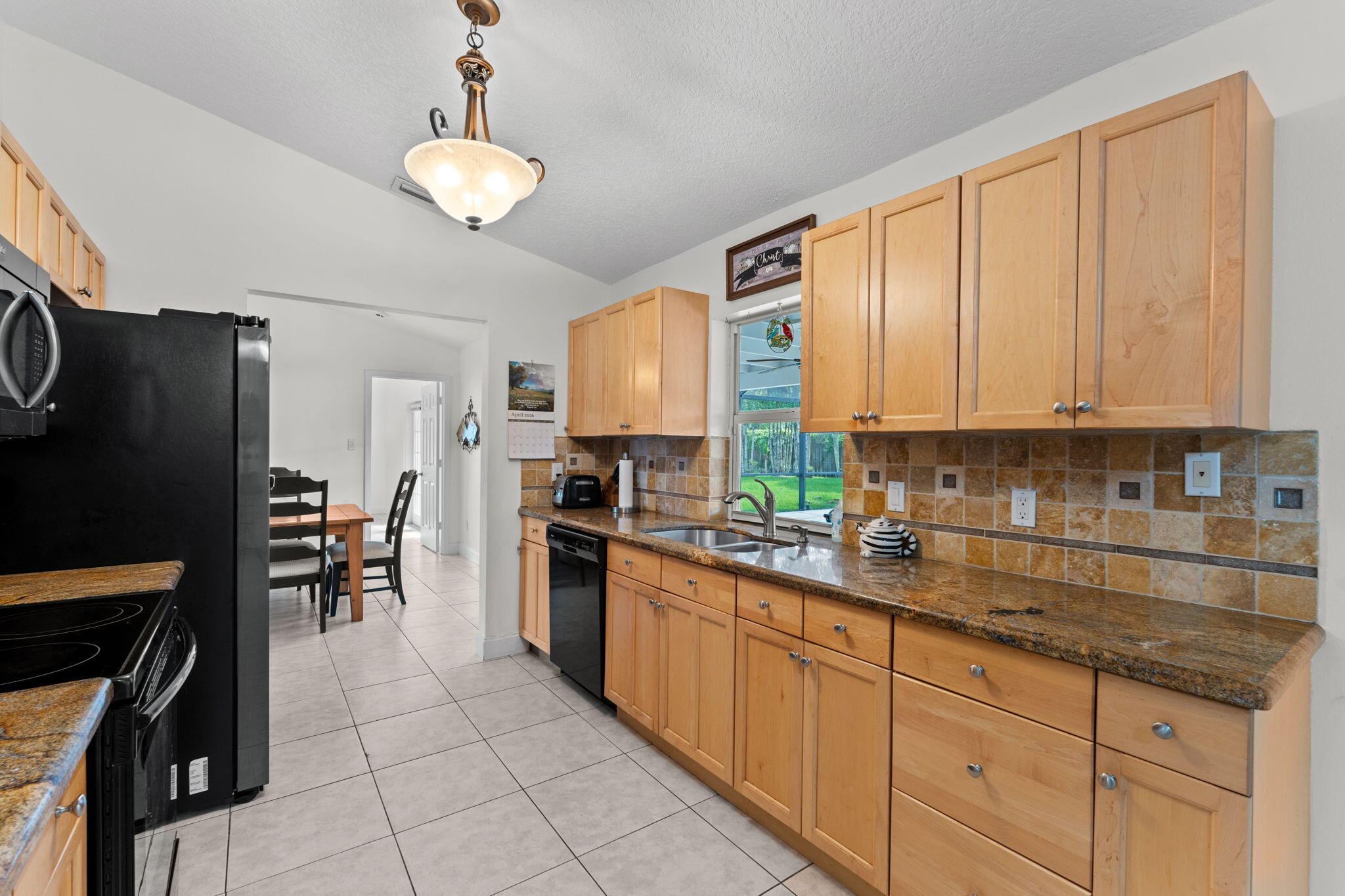 240 Sulky Way Wellington, FL 33414 - Photo 8 of 26 a kitchen with granite countertop a refrigerator stove top oven and sink