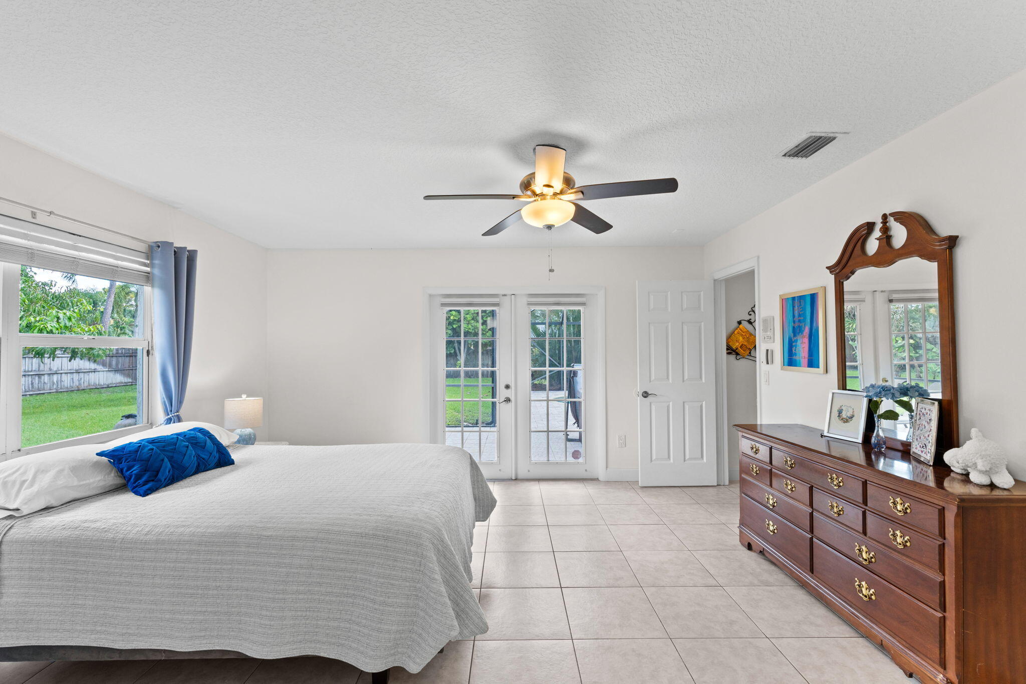 240 Sulky Way Wellington, FL 33414 - Photo 10 of 26 a bedroom with a bed dresser and a window