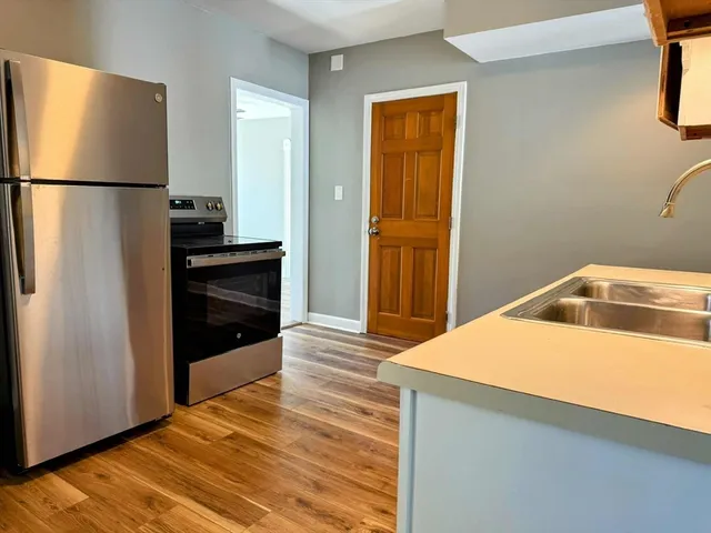 a kitchen with a refrigerator and a sink