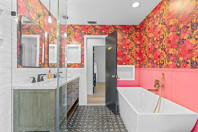 a bathroom with a tub sink and mirror