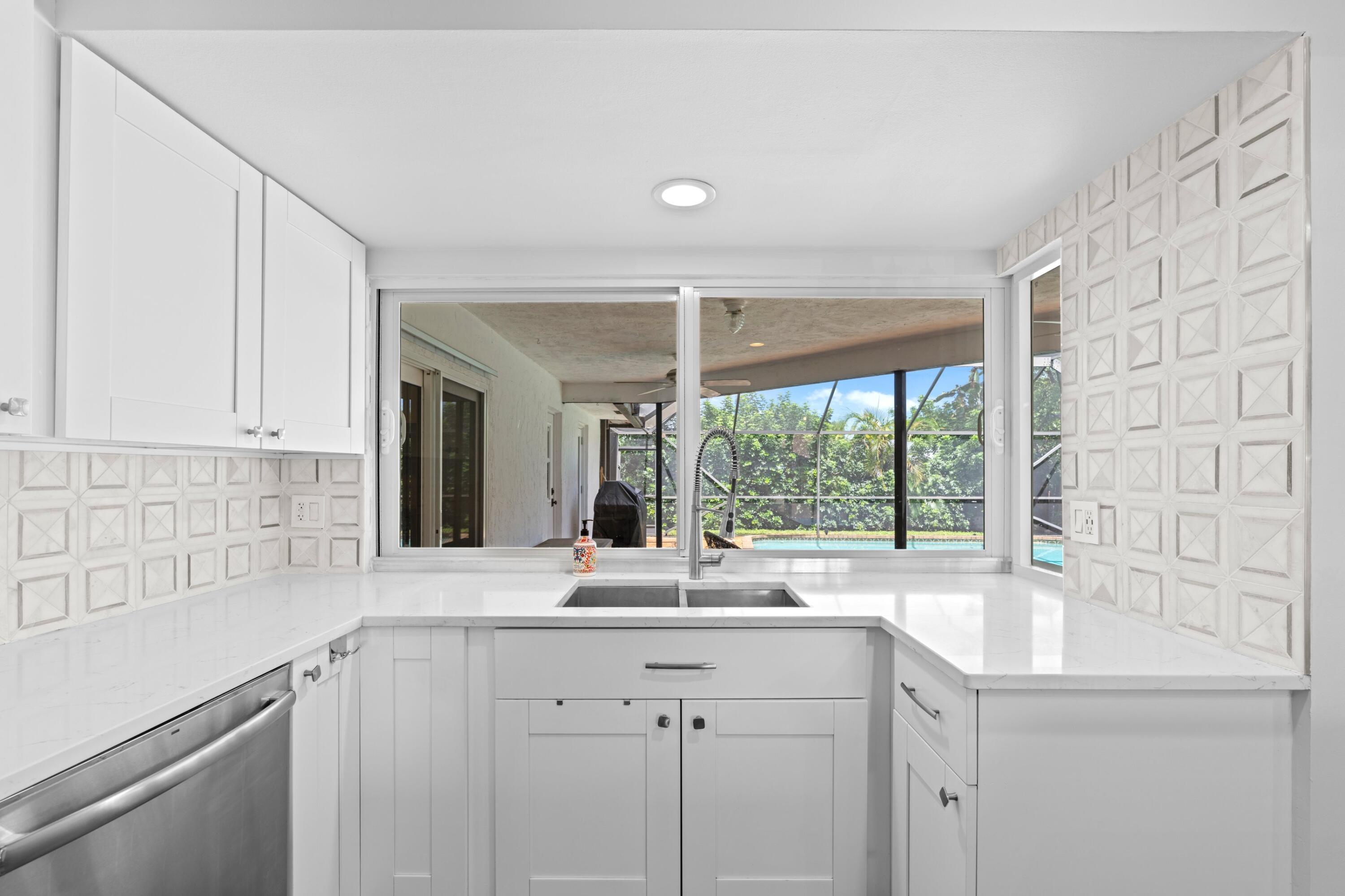1039 Northwest 8th Street Boca Raton, FL 33486 - Photo 5 of 17 a kitchen with a sink and large window