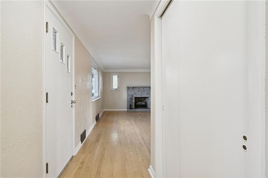 421 Robbins Station Road Irwin, PA 15642 - Photo 24 of 33 a view of a hallway with wooden floor and staircase