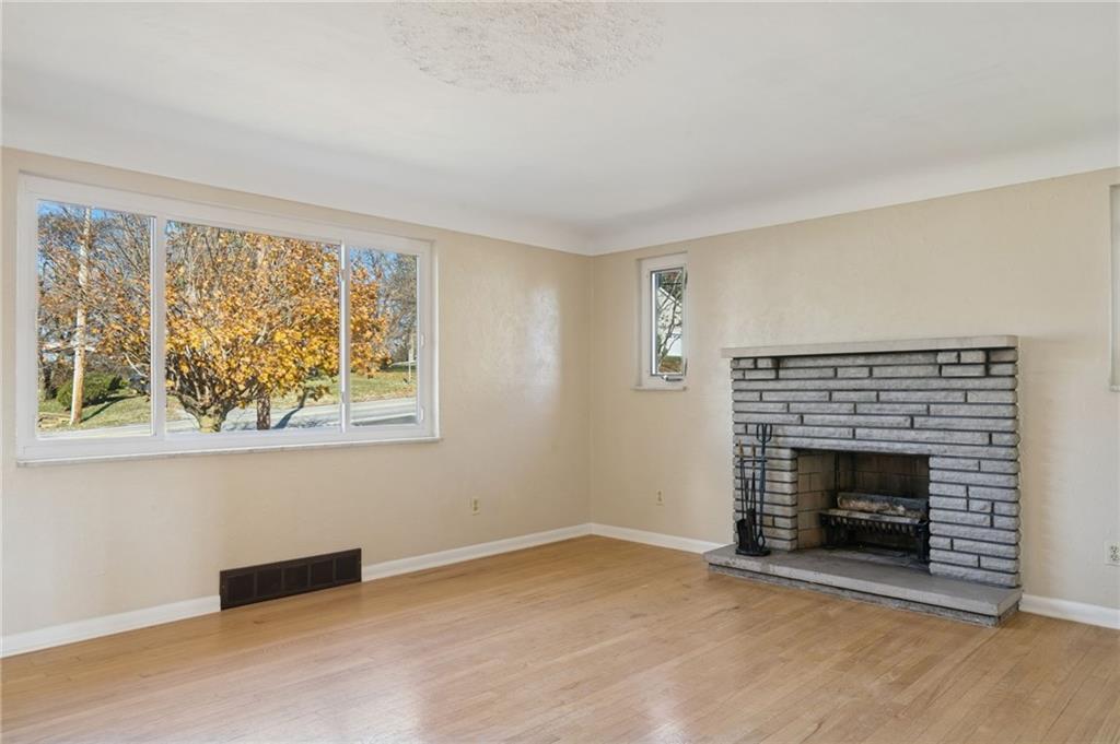 421 Robbins Station Road Irwin, PA 15642 - Photo 4 of 33 a view of an empty room with a fireplace and a window