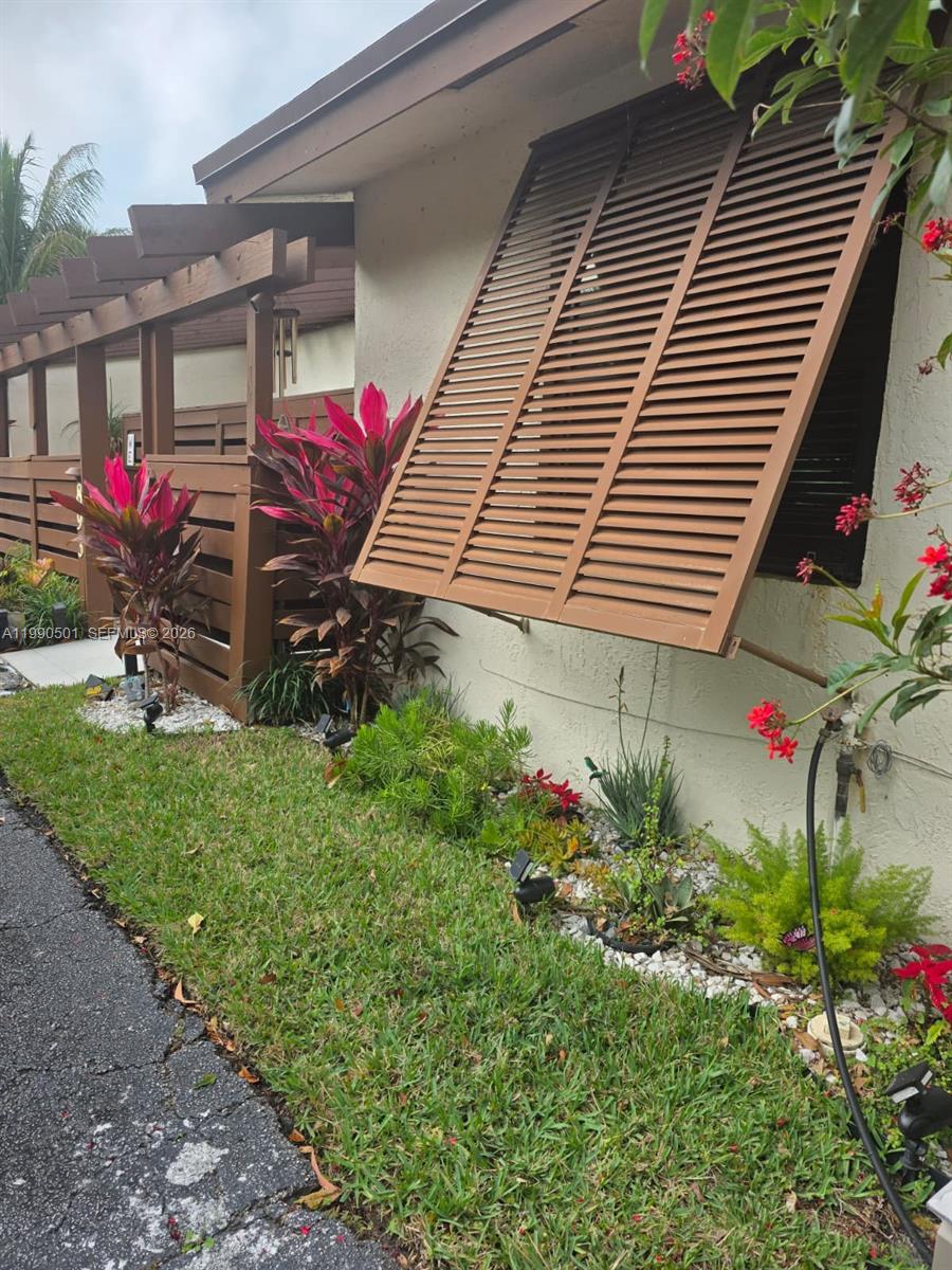 893 Southwest 120th Way Davie, FL 33325 - Photo 1 of 22 a view of a house with a yard and a garden