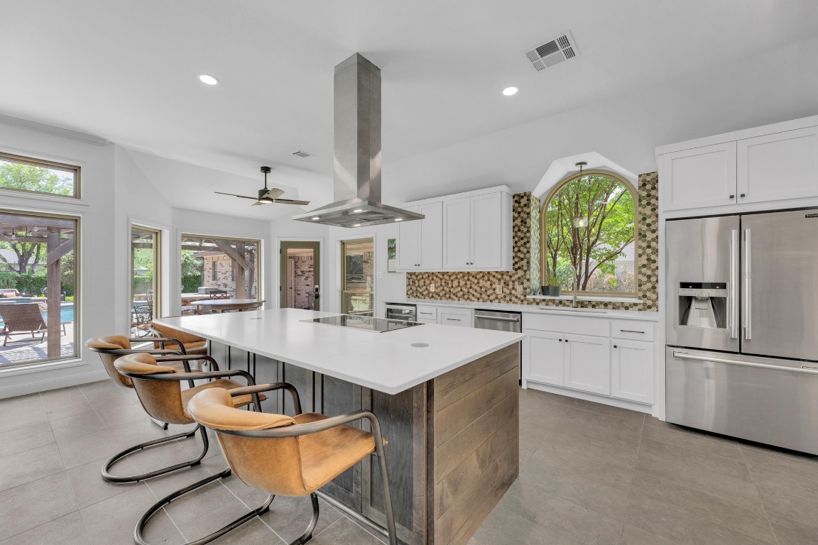 2 Meandering Way Round Rock, TX 78664 - Photo 13 of 39 a very nice looking kitchen with a large window cabinets and stainless steel appliances