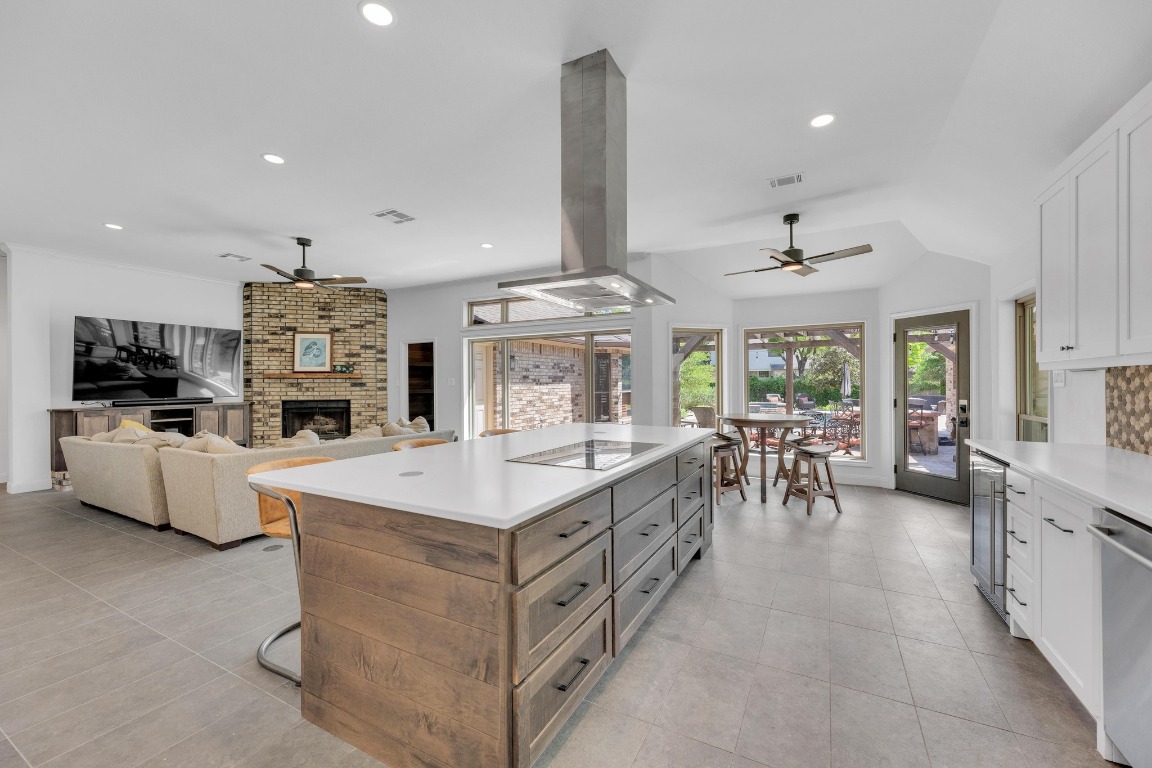 2 Meandering Way Round Rock, TX 78664 - Photo 17 of 39 a large kitchen with stainless steel appliances a stove center island a dining table and chairs