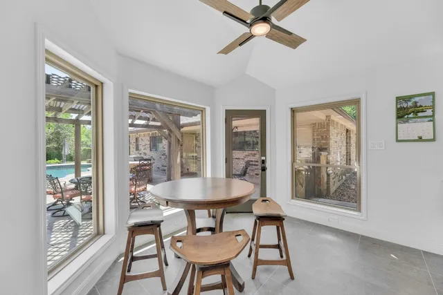 a dining room with furniture and window