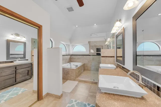 a large bathroom with a double vanity sink and a mirror