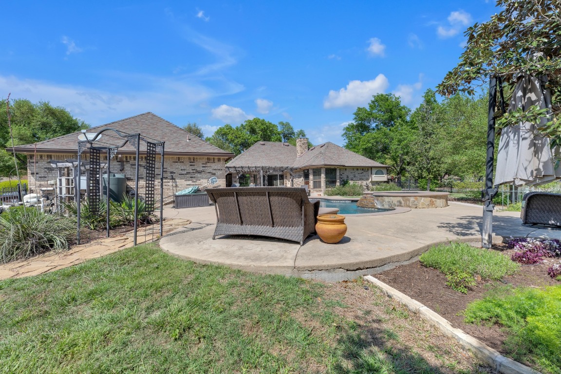 2 Meandering Way Round Rock, TX 78664 - Photo 37 of 39 a view of a patio with a table and chairs under an umbrella
