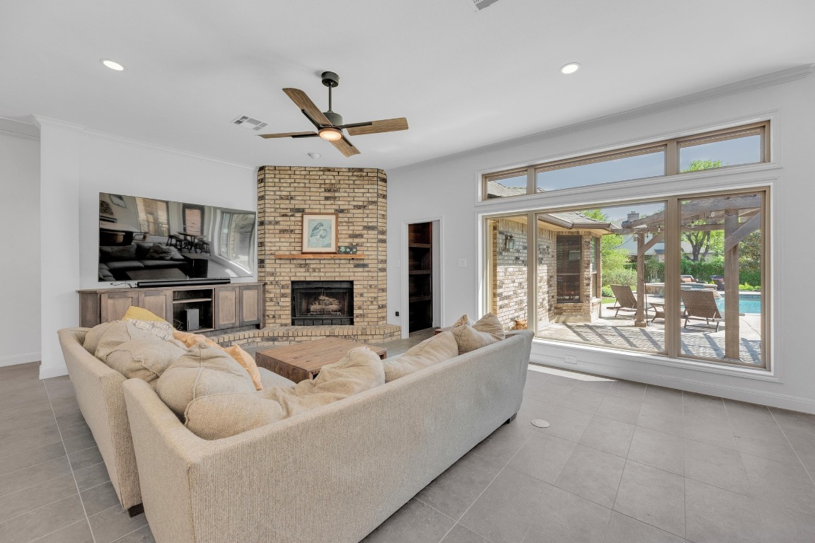 2 Meandering Way Round Rock, TX 78664 - Photo 7 of 39 a living room with furniture a flat screen tv and a fireplace