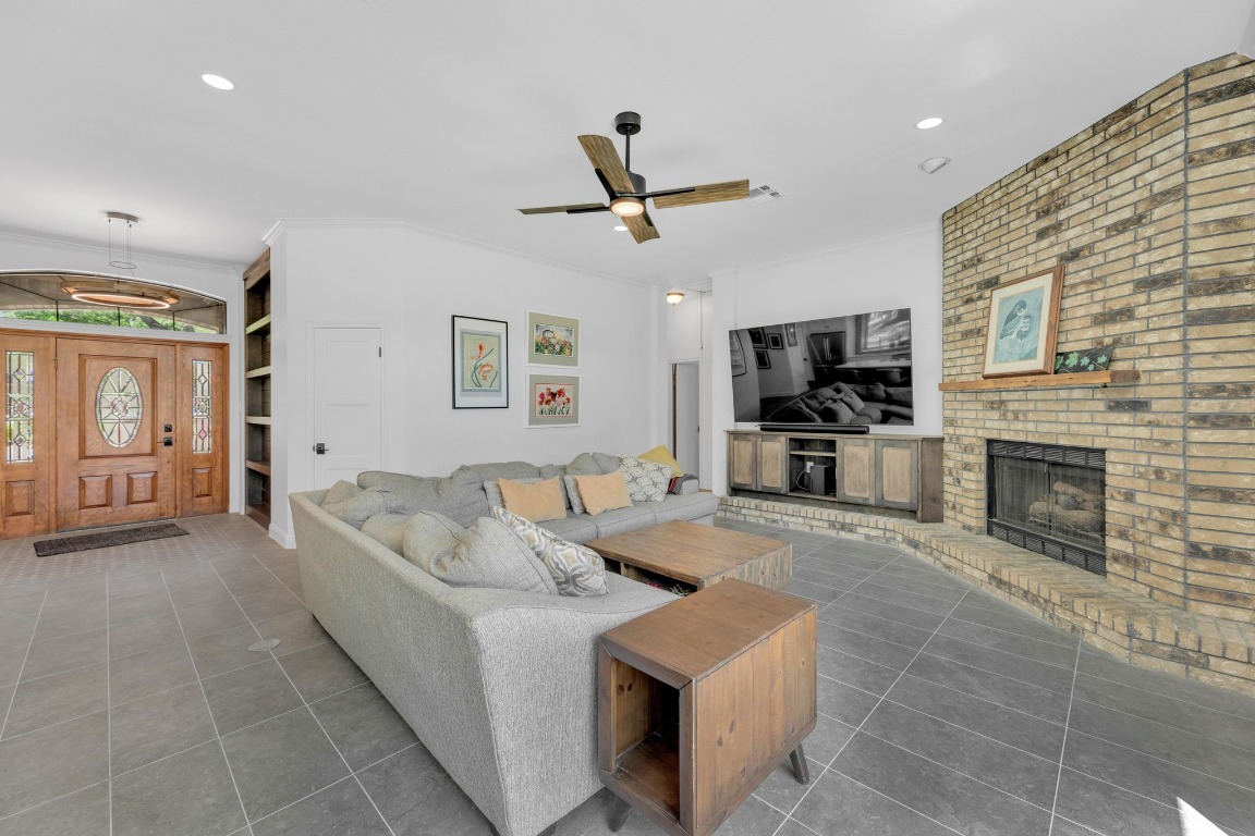 2 Meandering Way Round Rock, TX 78664 - Photo 8 of 39 a living room with furniture flat screen tv and a fireplace