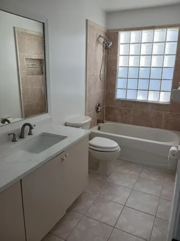a bathroom with a double vanity sink toilet and shower