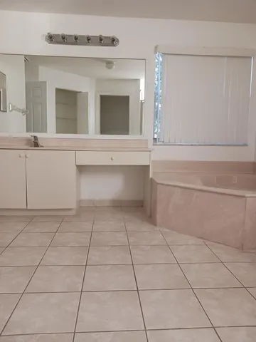 a bathroom with a vanity and a mirror