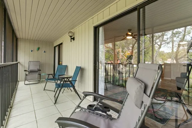 a view of a chairs and table in the balcony