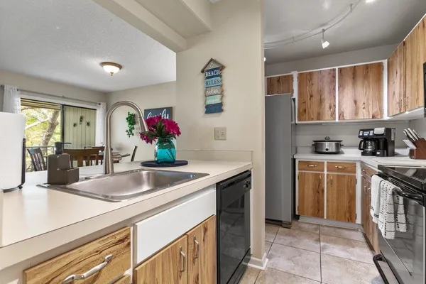a kitchen with a sink and a chandelier