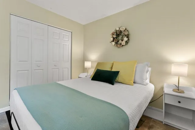 a bedroom with a bed and a desk