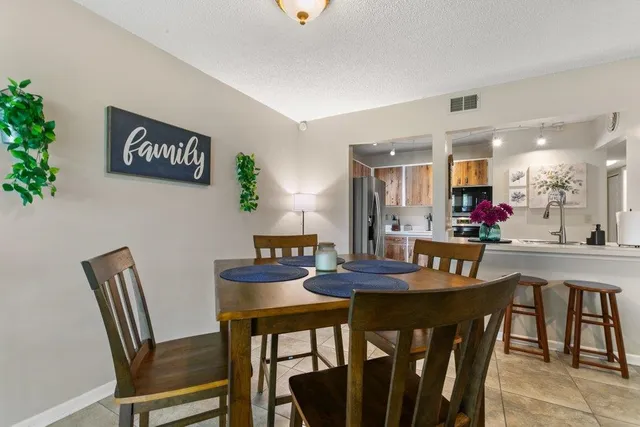 a view of a dining room with furniture and a chandelier