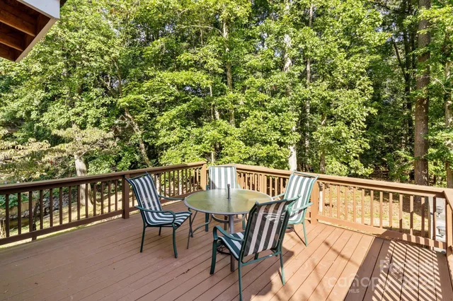 a view of a balcony with wooden floor and outdoor seating