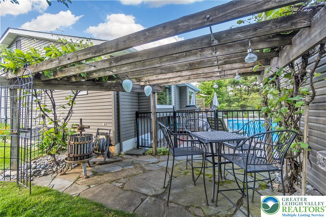 540 Briar Road Pen Argyl, PA 18072 - Photo 48 of 66 A private flagstone patio, shaded by a grapevine pergola, overlooks the shimmering pool.