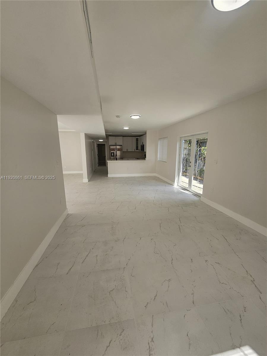 1361 Northwest 29th Terrace Miami, FL 33142 - Photo 2 of 7 a view of an empty room with a window