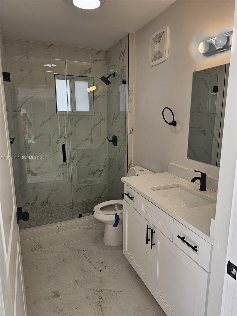 1361 Northwest 29th Terrace Miami, FL 33142 - Photo 4 of 7 a bathroom with a sink a toilet and shower