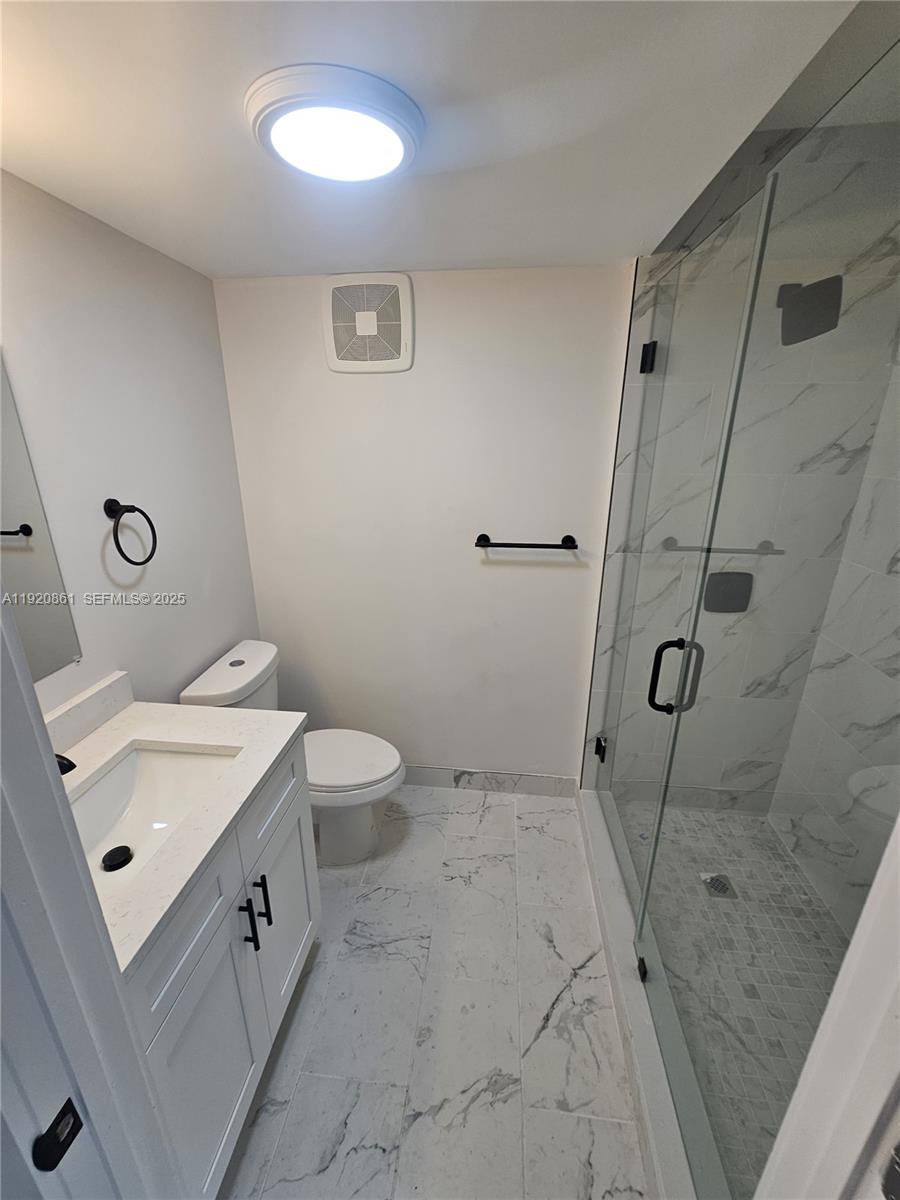 1361 Northwest 29th Terrace Miami, FL 33142 - Photo 6 of 7 a bathroom with a sink a toilet and shower