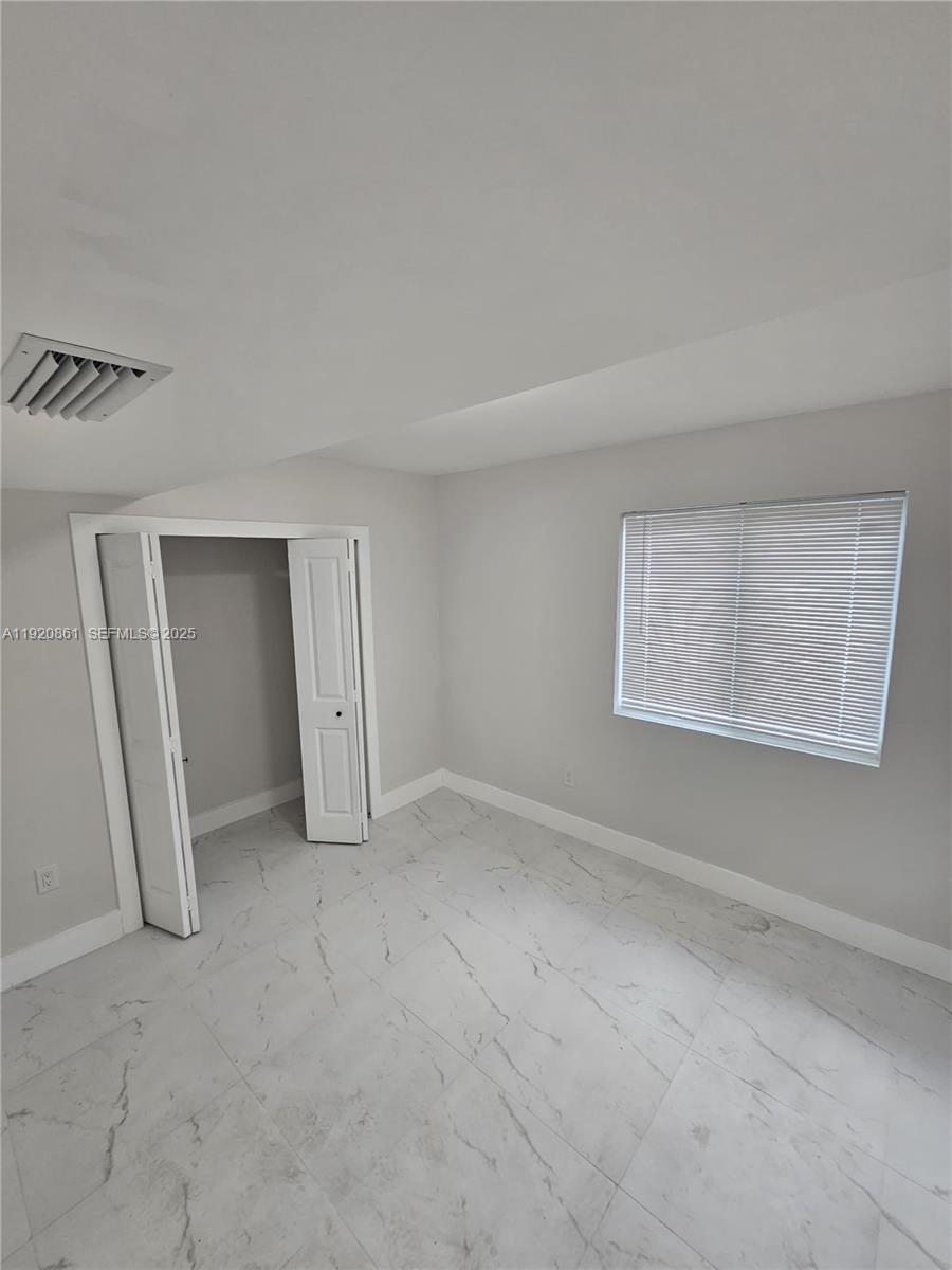 1361 Northwest 29th Terrace Miami, FL 33142 - Photo 7 of 7 an empty room with windows