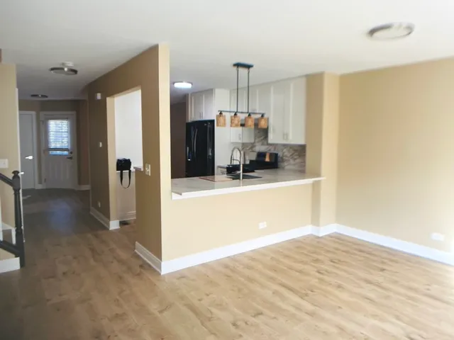 a view of a kitchen with a sink and cabinets